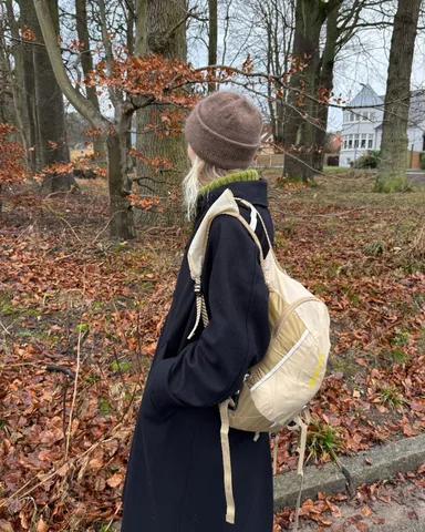 Brown Oslo hat seen from behind in an autumn forest setting.