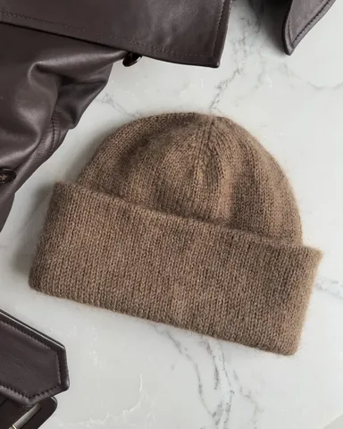 Brown Oslo hat against a white marble countertop.